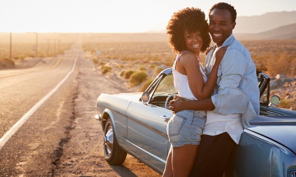 Black couple and a blue car